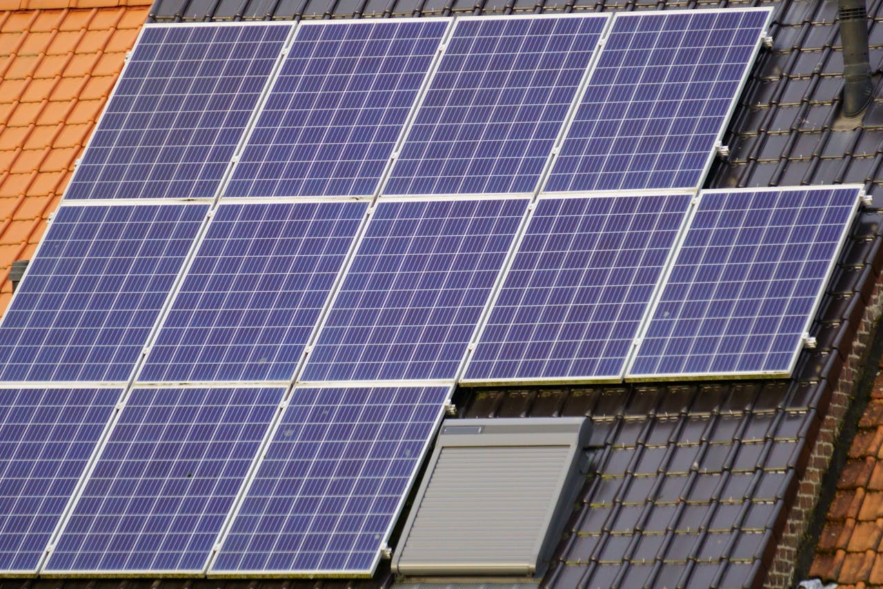 Services Close-up view of solar panels on a tiled rooftop, capturing clean energy.
