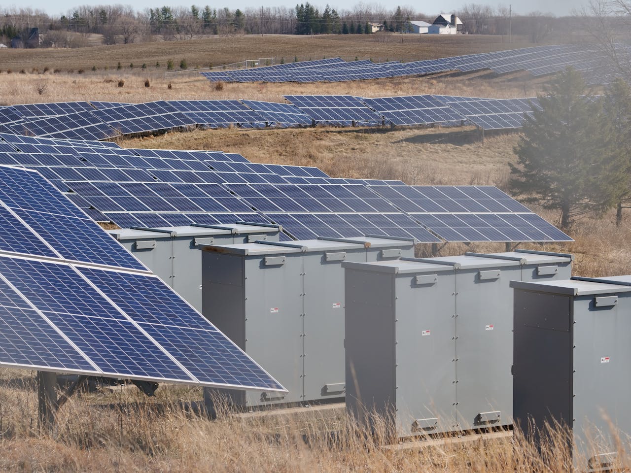 About Expansive solar panel field in a rural area harnessing solar energy. Sustainable and renewable energy source.