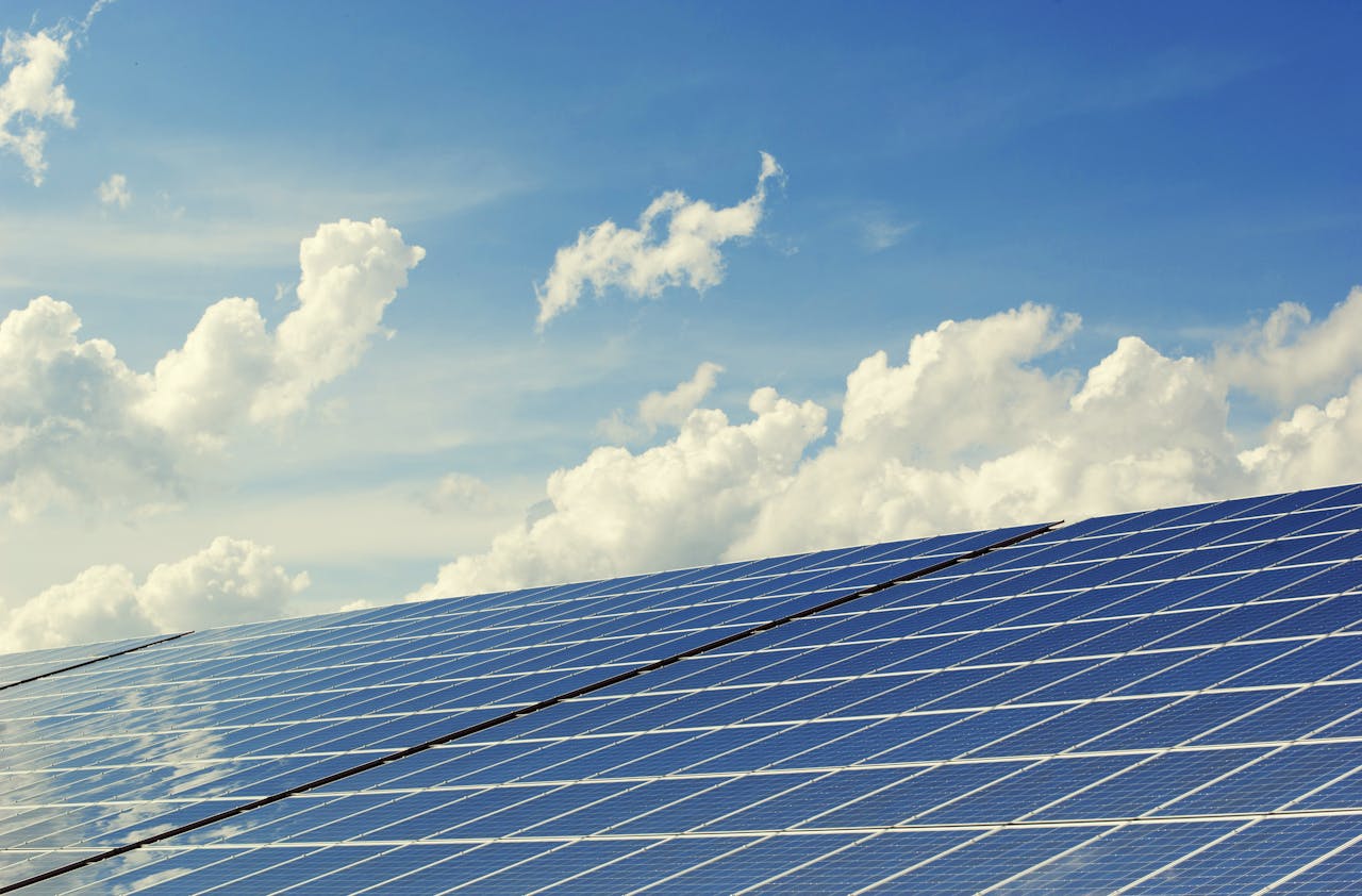 Crafting Captivating Headlines: Your awesome post title goes here Sleek modern solar panels under a vibrant blue sky with clouds, symbolizing clean energy.